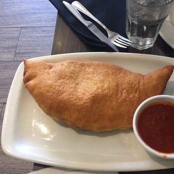 Abruzzo Pizza - Fried panzerotto with pepperoni and a side of tomato sauce - Italian Near Me - Richmond Hill, Ontario Abruzzo Pizza - Fried panzerotto with pepperoni and a side of tomato sauce - Italian Near Me - Richmond Hill, Ontario