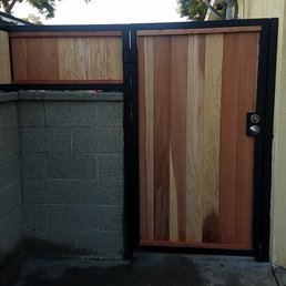 Heavy duty metal frame and red wood fencing and door.