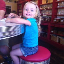 Candies on Main - There is a single table with a few stools at it. As well as benches along the front window.