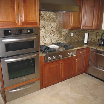 Sommer Construction - a kitchen with stainless steel appliances - General Contractors Near Me - Solana Beach, California
