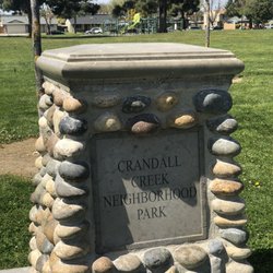 Signage in front. Children's playground in far right corner.