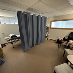 Prime Acupuncture - Office/consultation area separated from the treatment area with blackout curtains for patient privacy.