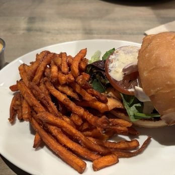 J. Wilson's - Salmon sandwich with sweet potato fries - New American Near Me - Lawrence, Kansas