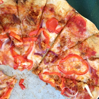 Skinny Pines - a sliced pizza with onions and tomatoes - Caterers Near Me
