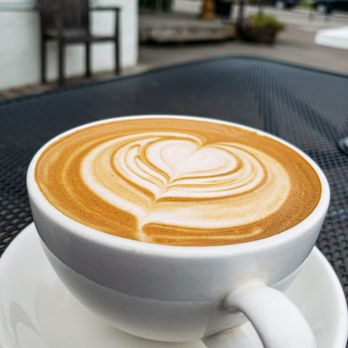 Weeds Cafe - a cup of coffee on a table - Coffee & Tea Near Me - Calgary, Alberta Weeds Cafe - a cup of coffee on a table - Coffee & Tea Near Me - Calgary, Alberta
