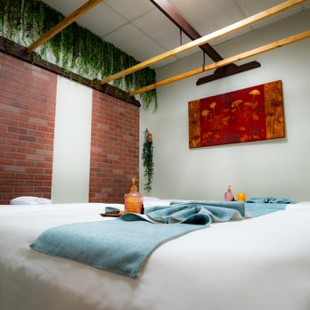 Jaidee Thai Massage - Elegant brick-accented treatment room at Jaidee - cascading ivy, curated greenery accents, and neatly arranged oils ready for your session. - Massage Therapy Near Me - Spring, Texas Jaidee Thai Massage - Elegant brick-accented treatment room at Jaidee - cascading ivy, curated greenery accents, and neatly arranged oils ready for your session. - Massage Therapy Near Me - Spring, Texas