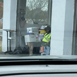 Green Drop - Employee sitting with his phone ignoring costumers driving in.
