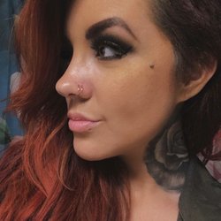 Wingnut Tattoo & Piercing Studio - Dermal with gold setting, and two single gold hoops in the nose.