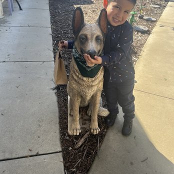 The Luffa Farm - Their welcome dog (statue) & my son with his Dino shaped glycerin soap. (In the baggy) - Tours Near Me - Nipomo, California