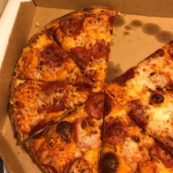 Domino's Pizza - Burned crust I went and looked at Dominos website and I did not see any of the pictures of the pizza on the website look like this