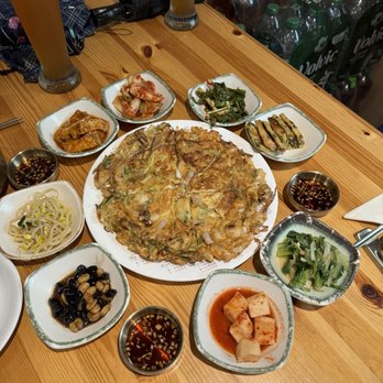 Mr. Lee - Haemul pajeon in the middle and banchans - Korean Near Me - Frankfurt, HE Mr. Lee - Haemul pajeon in the middle and banchans - Korean Near Me - Frankfurt, HE
