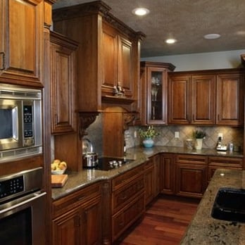 Beyond Remodeling - a kitchen with wood cabinets and granite countertops - General Contractors Near Me Beyond Remodeling - a kitchen with wood cabinets and granite countertops - General Contractors Near Me