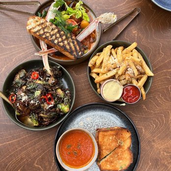 H Tasting Lounge - Clockwise from top: HTL Cioppino, truffle fries, lobster & prosciutto grilled cheese, crispy brussels sprouts. - Lounges Near Me - Vancouver, British Columbia