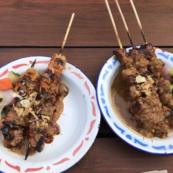 Wajan - 06.28.19 SKEWERSZZ chicken n pork (idk why they brought out the third skewer missing from left plate later instead of all at once) - Indonesian Near Me - Portland, Oregon Wajan - 06.28.19 SKEWERSZZ chicken n pork (idk why they brought out the third skewer missing from left plate later instead of all at once) - Indonesian Near Me - Portland, Oregon