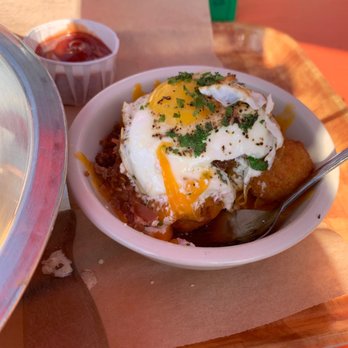 Rodeo Goat - Steaming pile, simply delicious. Creamy goat cheese over bacon cheese and tater tots, topped with a fried egg. - Burgers Near Me - Houston, Texas