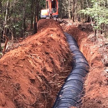 Trantham Excavating & Grading - a trench being built in the woods - General Contractors Near Me Trantham Excavating & Grading - a trench being built in the woods - General Contractors Near Me