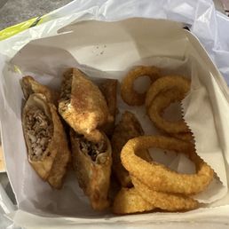 Jerk chicken egg rolls with onion rings. It looks small but, it's a very generous portion. Jerk chicken egg rolls with onion rings. It looks small but, it's a very generous portion.
