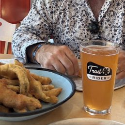 Green chile appetizer with house made Extra Green Chile Ranch, tractor blood oranger cider, and agua frieo Pilsner