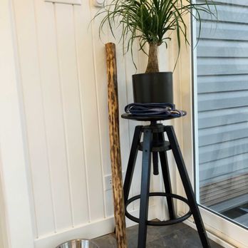 Buildcraft - a potted plant on a stool next to a bowl - General Contractors Near Me - Bellefontaine, Ohio Buildcraft - a potted plant on a stool next to a bowl - General Contractors Near Me - Bellefontaine, Ohio
