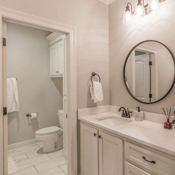 Heritage Crafted Homes - a bathroom with a sink, toilet, and mirror - General Contractors Near Me - San Antonio, Texas