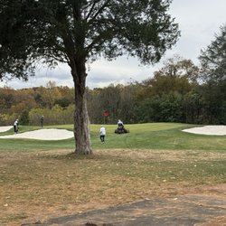 Prince William Golf Course - Actively mowing around players. Players were there first not the mower.