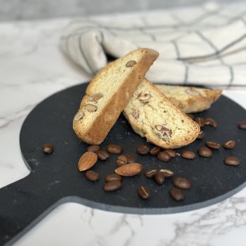 Mama Fontana - two pieces of biscotti on a plate with coffee beans - Bakeries Near Me - Houston, Texas