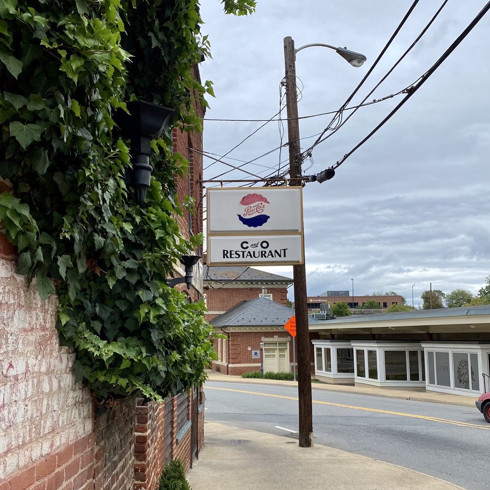 C & O Restaurant - a brick building with a sign on it - New American Near Me - Charlottesville, Virginia