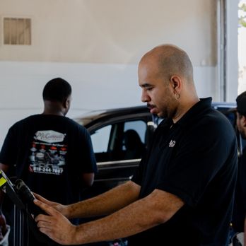McConnell Auto Glass - Technician aligning calibration frame to the center of the vehicle. - Windshield Installation & Repair Near Me - Raleigh, North Carolina McConnell Auto Glass - Technician aligning calibration frame to the center of the vehicle. - Windshield Installation & Repair Near Me - Raleigh, North Carolina