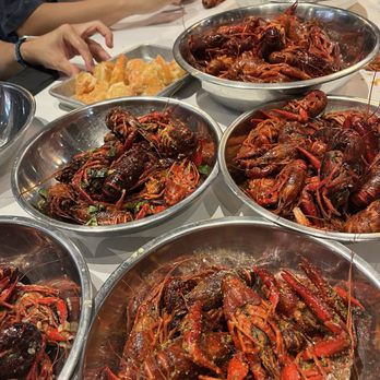Crawfish Cafe - variety of sauces: original cajun, garlic butter, lemon pepper, thai basil with added corn and sausage - Seafood Near Me - Houston, Texas