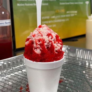 Zydeco Snow - a cup of ice cream with a spoon sticking out of it - Shaved Snow Near Me Zydeco Snow - a cup of ice cream with a spoon sticking out of it - Shaved Snow Near Me
