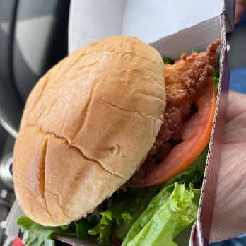 Chick-fil-A - ows a hand holding a sandwich - Fast Food Near Me - Beaverton, Oregon Chick-fil-A - ows a hand holding a sandwich - Fast Food Near Me - Beaverton, Oregon
