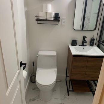 Jet Tile - a bathroom with a toilet, sink and mirror - Flooring Near Me - Antioch, California