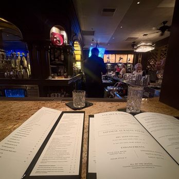 Del Frisco's Double Eagle Steakhouse - A couple of menus with a glass of water at the bar - Steakhouses Near Me - Denver, Colorado Del Frisco's Double Eagle Steakhouse - A couple of menus with a glass of water at the bar - Steakhouses Near Me - Denver, Colorado