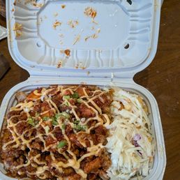 sweet and spicy chicken thighs over fries and slaw