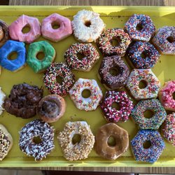 Sachse Donuts - Frosted sprinkle donuts (chocolate, strawberry, vanilla frostings), cinnamon roll donuts, maple donuts, coconut topped donuts, peanut donuts