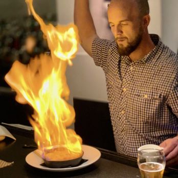 Nostos - Daniel Smith preparing Saganaki! Delicious! - Greek Near Me - Vienna, Virginia Nostos - Daniel Smith preparing Saganaki! Delicious! - Greek Near Me - Vienna, Virginia
