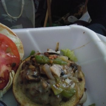 Hootie's Burger Bar - a hamburger and a tomato - Food Delivery Services Near Me - Omaha, Nebraska