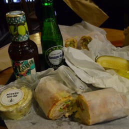 Turkey sandwich and pickle. Accompanied by drinks. Turkey sandwich and pickle. Accompanied by drinks.