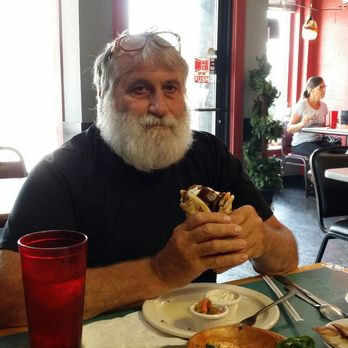 Mediterranean Grill - Eating a gyro with taziki sauce. Loving it! - Mediterranean Near Me - Clarksville, Tennessee Mediterranean Grill - Eating a gyro with taziki sauce. Loving it! - Mediterranean Near Me - Clarksville, Tennessee