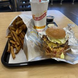 Double bacon cheeseburger with fries and a drink
