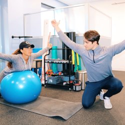 Spark Health - Spark's exercise specialist educating a patient on proper exercise technique