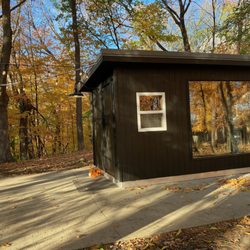 Voyageur Custom Saunas - Backyard Sauna 8x12, Stained black exterior, large window in hot room