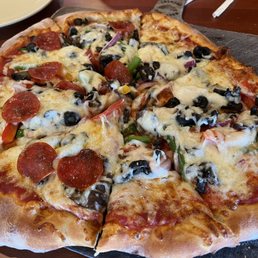 Veggie pizza with pepperoni on one side Veggie pizza with pepperoni on one side