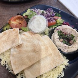 The chicken kebab plate. Chicken is hidden under the pita. The chicken kebab plate. Chicken is hidden under the pita.