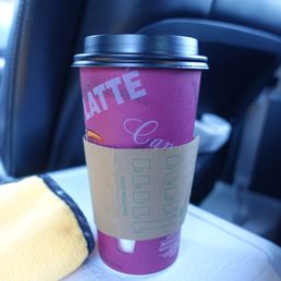 a cup of coffee on a car seat a cup of coffee on a car seat