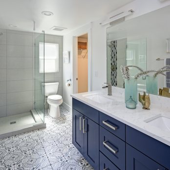 JV Remodeling - a bathroom with blue cabinets and white countertops - General Contractors Near Me JV Remodeling - a bathroom with blue cabinets and white countertops - General Contractors Near Me