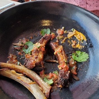 Maximón - Pork ribs half way through enjoying them - Latin American Near Me - Baltimore, Maryland