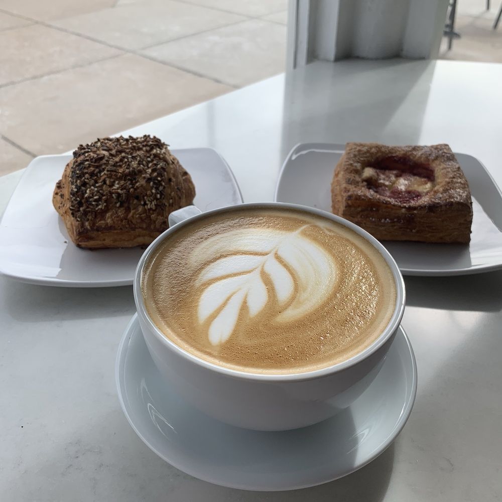 a cup of cappuccino and two pastries a cup of cappuccino and two pastries