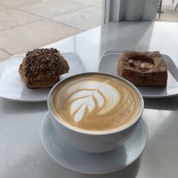 a cup of cappuccino and two pastries