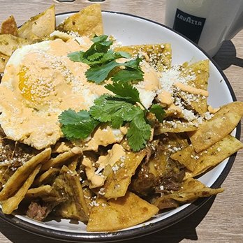 Toasted La Mesa - The Chilaquiles with perfectly cooked sunny eggs, and a spicy Chile Verde Barbacoa. The texture was flawless. - Breakfast & Brunch Near Me - La Mesa, California